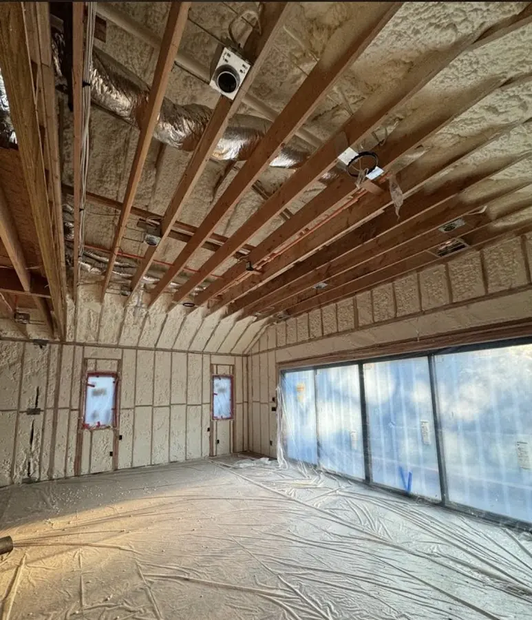Interior walls and ceiling insulated with spray foam during new construction in Middlebury